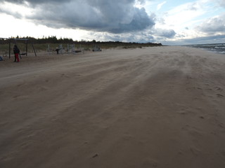 Lonely beach. Strong wind blowing sand