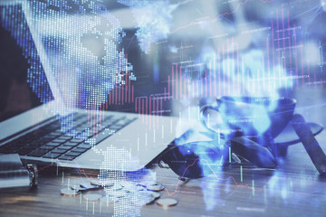 Financial graph colorful drawing and table with computer on background. Double exposure. Concept of international markets.