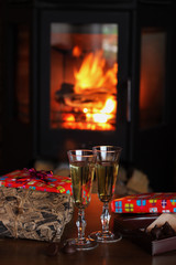 Champagne glasses on the background of the fireplace