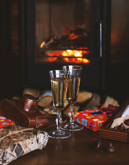 Champagne glasses on the background of the fireplace