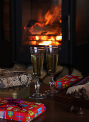 Champagne glasses on the background of the fireplace