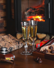 Champagne glasses on the background of the fireplace