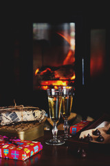 Champagne glasses on the background of the fireplace