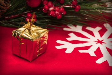 Christmas decorations and gifts on a red background with a white snowflake. Winter holiday concept