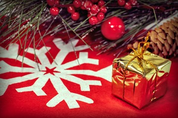 Christmas decorations and gifts on a red background with a white snowflake. Winter holiday concept