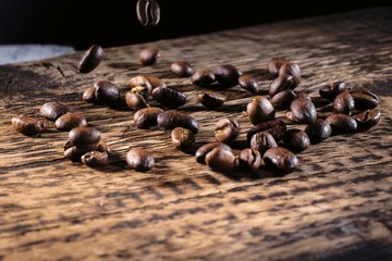 Coffee beans on a textured wooden background