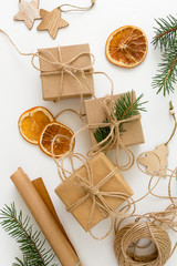 Christmas flat lay gifts in boxes in eco friendly packaging on a white background, Christmas zero waste, ecology