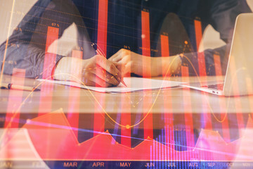 Double exposure hands with stock market chart.