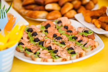 buffet for celebration birthday food on plates, home made sandwiches and decorations