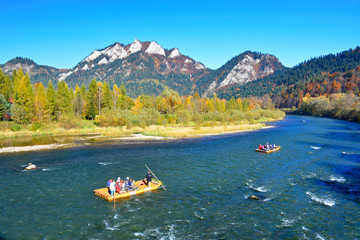 Raft with tourist on Dunajec river in autumn landscape of Pieniny mountains