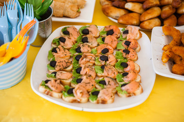 buffet for celebration birthday food on plates, home made sandwiches and decorations