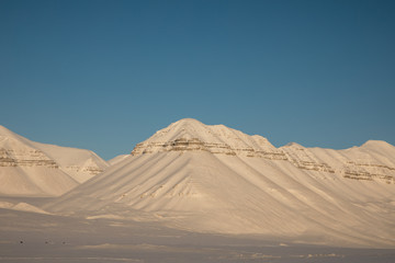 Beautiful arctic winter landscape with snow covered mountains on Svalbard, Norway