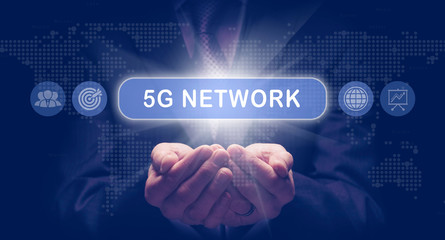 Businessmans cupped hands holding a 5G Network business concept on a computerised display.