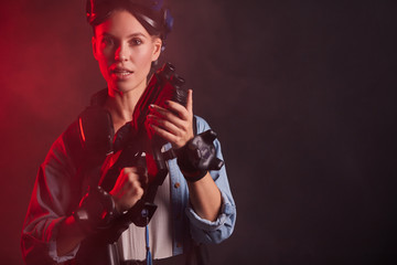 Beautiful caucasian female holding vr gun, ready to shoot. Isolated smoky background