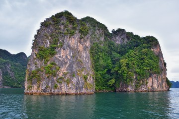 Island, Ocean views near Phuket Thailand with Blues, Turquoise and Greens oceans, mountains, boats, caves, trees resort island of phuket Thailand. Including Phi Phi, Ko Rang Yai, Ko Li Pe and other is