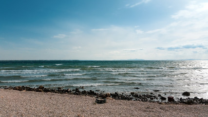 Fototapeta na wymiar View of beach with blue sky and clouds. Vir, Croatia