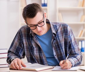 Young student preparing to school exams with books