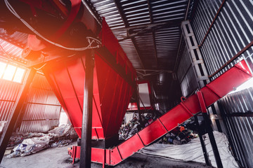 At modern recycling plant. Conveyor belt for transports garbage inside a drum filter.