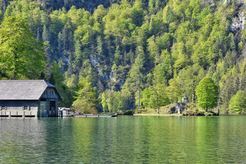 Fototapeta premium Berchtesgaden, Germany - May 2019. Berchtesgaden National Park, Bavaria (Bayern), Germany. Passenger boat on the Koenigssee lake. Beautiful view of nature near Konigssee lake. electric boat