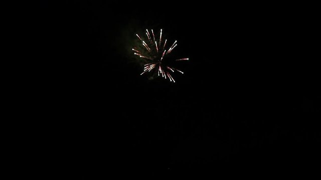 Explosion of bright colorful part of fireworks on black background to create a set salute on video for holiday new year, birthday, wedding or other celebration.
