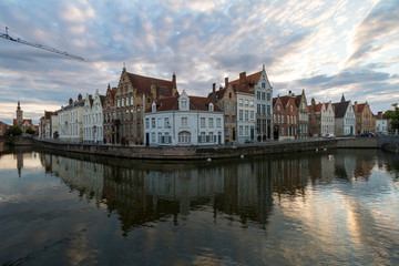 Bruges, Belgium. Panoramic view of houses along the canal embankment at sunset