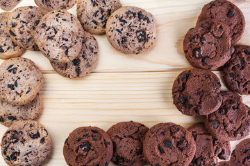 Tasty cookies with chocolate chips placed on a wooden background . Selective focus shot.