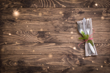 Christmas table place setting with linen napkin on the wooden background