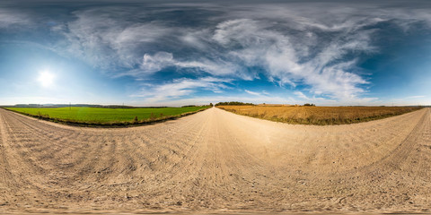 full seamless spherical hdri panorama 360 degrees angle view on gravel road among fields in autumn sunny day with awesome clouds in equirectangular projection, ready for VR AR virtual reality