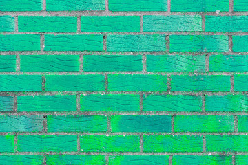 Brick wall painted in bright turquoise color. The texture of the brickwork.