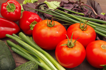 Summer vegetables and greens on a rustic table
