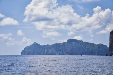 Naklejka na ściany i meble Island, Ocean views near Phuket Thailand with Blues, Turquoise and Greens oceans, mountains, boats, caves, trees resort island of phuket Thailand. Including Phi Phi, Ko Rang Yai, Ko Li Pe and other is
