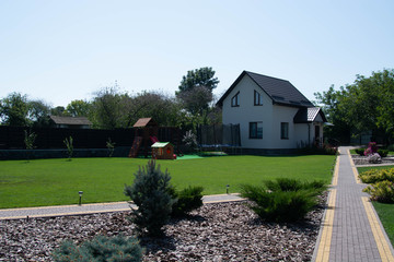 Modern house with green lawn, exterior view
