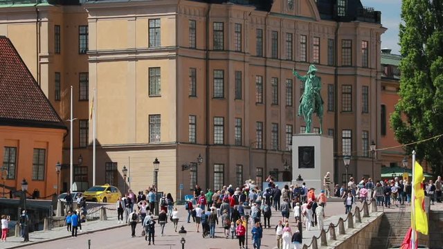 Stockholm, Sweden. Crowd Of Tourists People Walking In Stockholm Old Town. Gamla Stan In Summer Day. Famous Popular Destination Scenic Place. UNESCO World Heritage Site. Karl XIV Johans Satatue