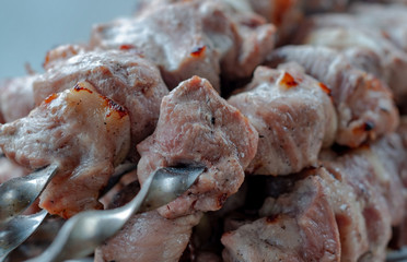 Kebab - pieces of pork and chopped onion strung on skewers, photographed close-up