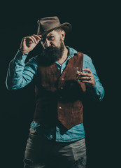 Whisky elegant. Man with beard holds glass of brandy. Bearded businessman in elegant suit with glass of whiskey.