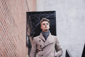 young man in autumn coat on the street