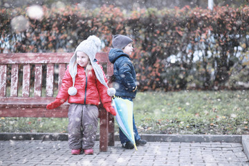 Obraz premium Kids walk in the park first snow