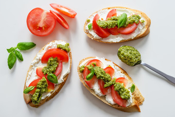 Toast with soft mascarpone cheese, tomatoes and fresh basil pesto