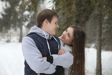 Fototapeta premium pair of lovers on a date winter afternoon in a snow blizzard