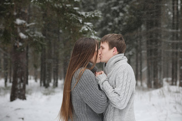 pair of lovers on a date winter afternoon in a snow blizzard
