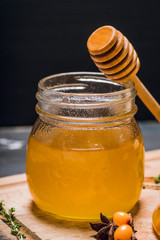 Honey jar on the rustic background. Selective focus.