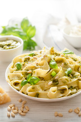Large portion of noodles with fresh basil pesto and pine nuts