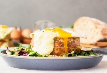 Croque Madame - hot french sandwich with ham, melted emmental cheese, fried egg and bechamel sauce with salad. Delicious breakfast. food, sandwich, cheese, breakfast, bread