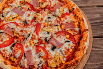 Pepperoni Pizza with Mozzarella cheese, Ham, Tomatoes, pepper, Spices . Italian pizza.