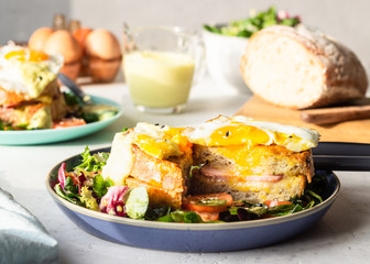 Croque Madame - hot french sandwich with ham, melted emmental cheese, fried egg and bechamel sauce with salad. Delicious breakfast. food, sandwich, cheese, breakfast, bread