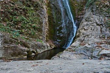 Fototapeta na wymiar Autumn view of bottom part at waterfall Skoka or Jump of river Kozniza in Central Balkan, near to Teteven town, Bulgaria 