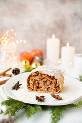 Fototapeta na wymiar Christmas and new year dessert. Apple pie in festive decorations, with garlands and Christmas toys.