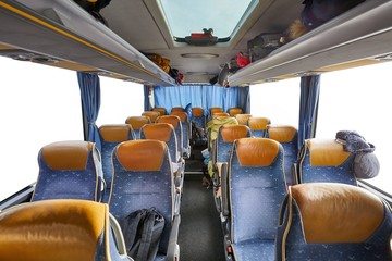 Bus interior empty seats, stop on a long distance trip, blanked out windows with copy space