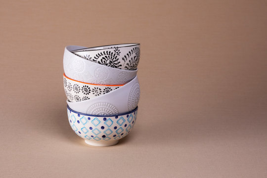 Stack Of Trendy And Mismatched Pattern Ceramic Bowls With Text Space