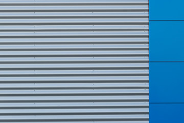 Geometric colored building facade elements with planes, lines and corners with light flare and reflections for an abstract background and texture of white, blue, gray colors. Place for text